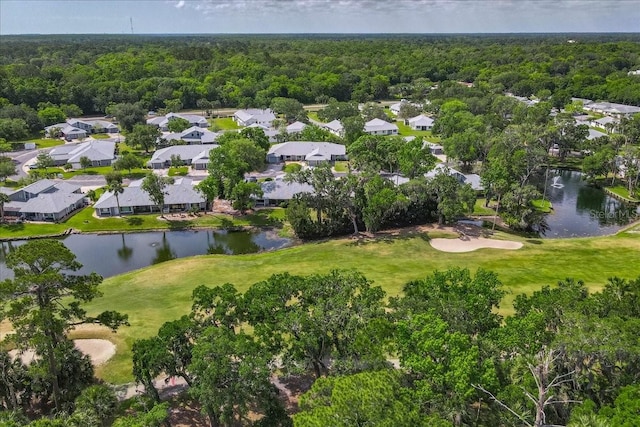 birds eye view of property with a residential view, a water view, and view of golf course