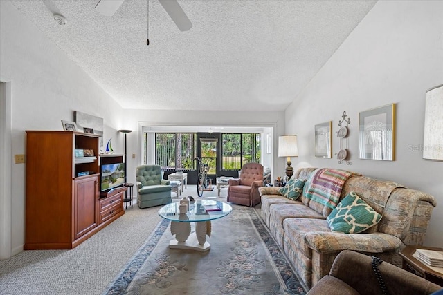 living room with a textured ceiling, a ceiling fan, vaulted ceiling, and light colored carpet