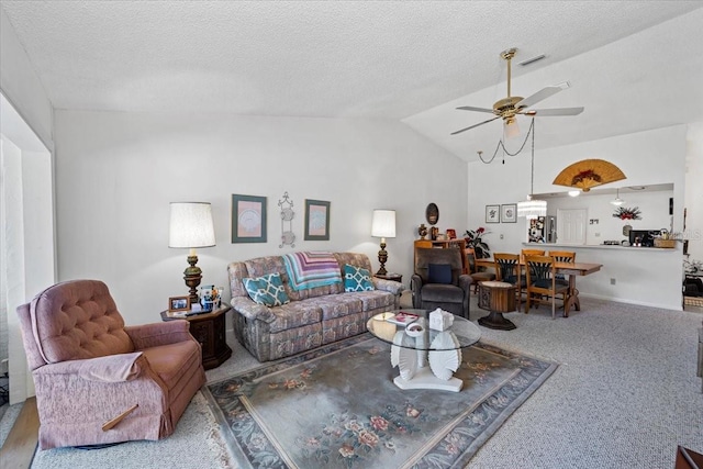carpeted living area featuring a textured ceiling, visible vents, a ceiling fan, and vaulted ceiling