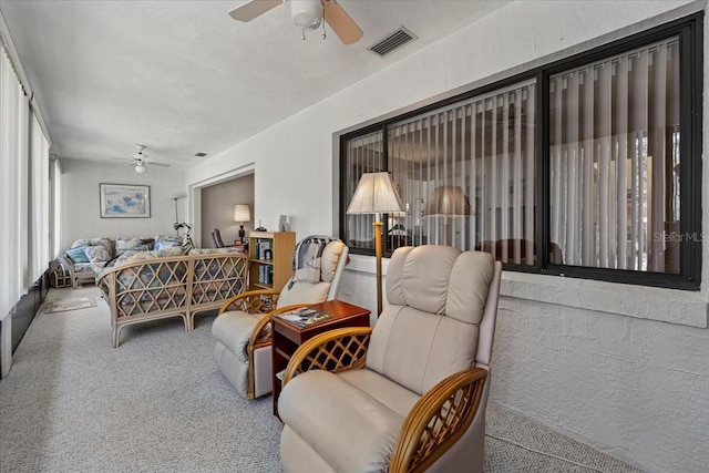 carpeted bedroom with visible vents and ceiling fan