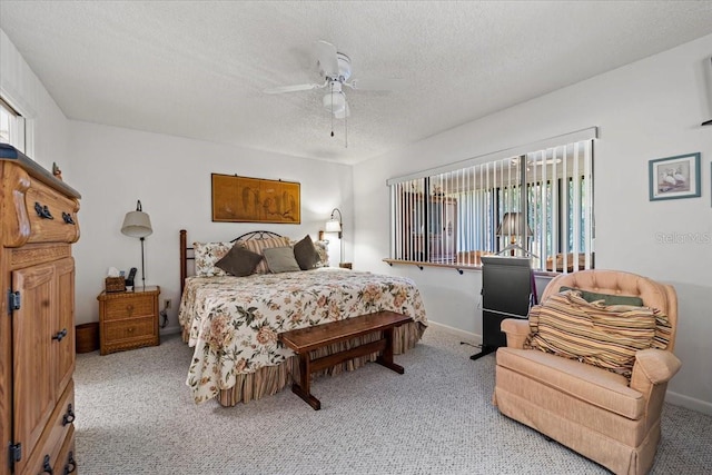 bedroom featuring a textured ceiling, a ceiling fan, carpet floors, and baseboards