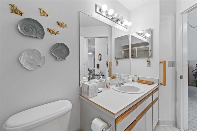 bathroom with toilet and vanity