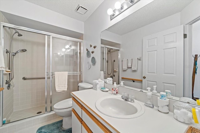 full bath with toilet, visible vents, a shower stall, and vanity
