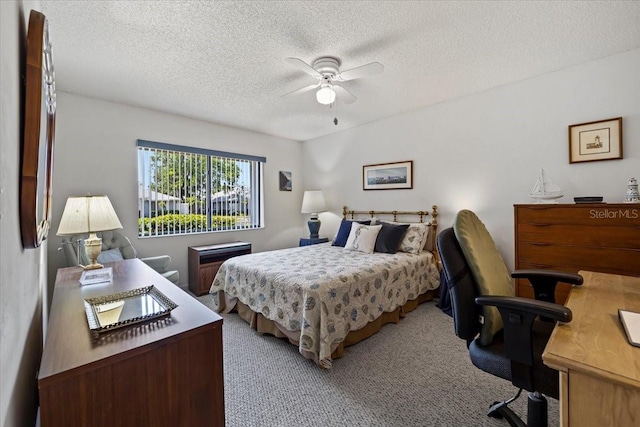 carpeted bedroom featuring a textured ceiling and a ceiling fan