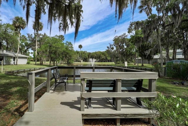 view of property's community with a yard and a water view