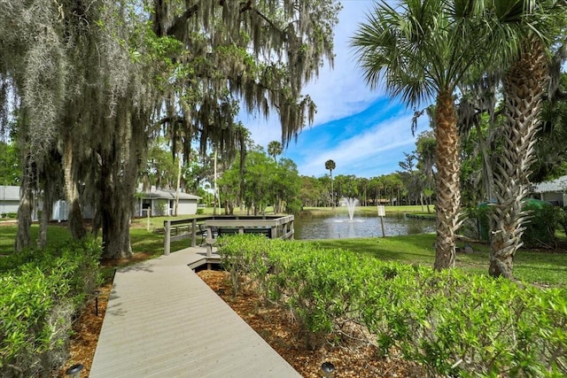 view of community featuring a yard and a water view