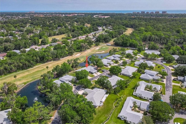 birds eye view of property with a residential view, a water view, and view of golf course