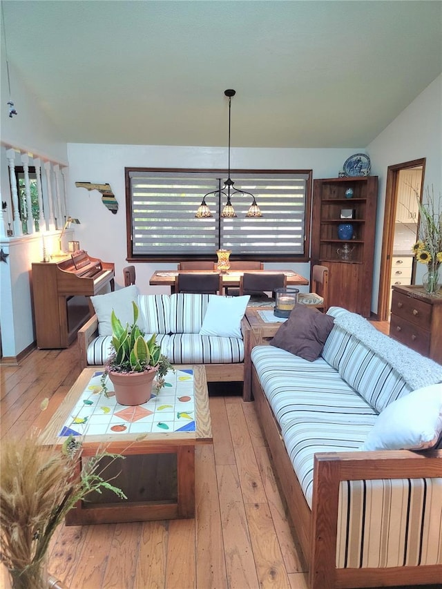 living room featuring a notable chandelier and wood-type flooring