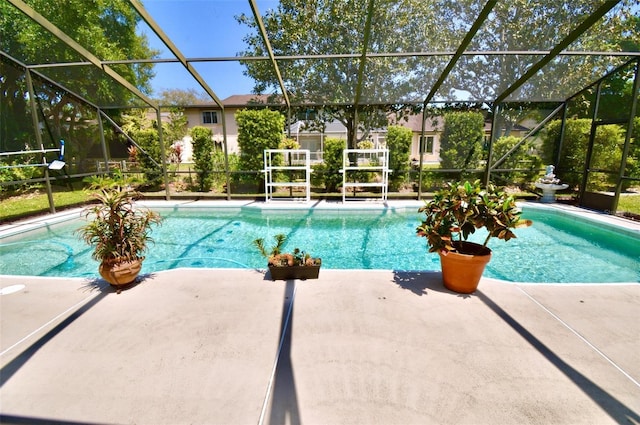 pool with glass enclosure and a patio