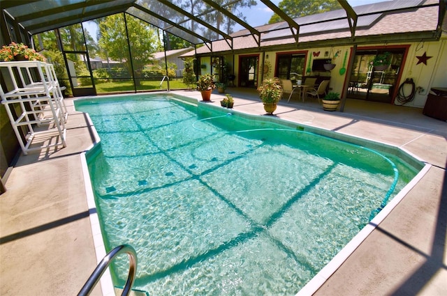 outdoor pool with a lanai and a patio