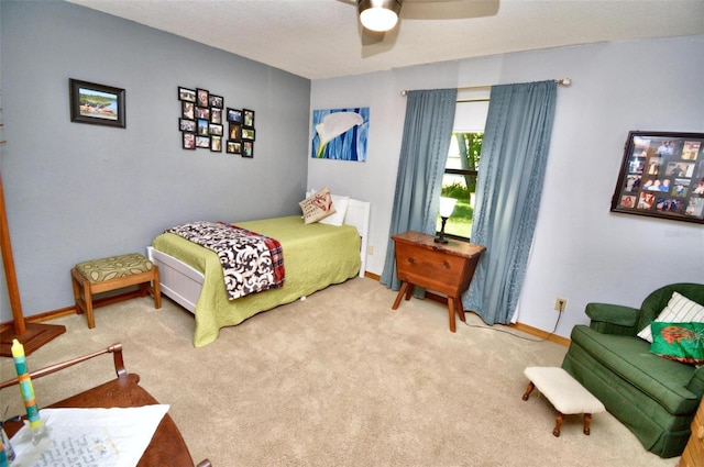 carpeted bedroom featuring baseboards and ceiling fan