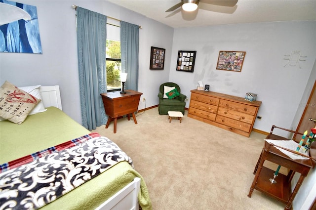 bedroom with a ceiling fan, carpet flooring, and baseboards