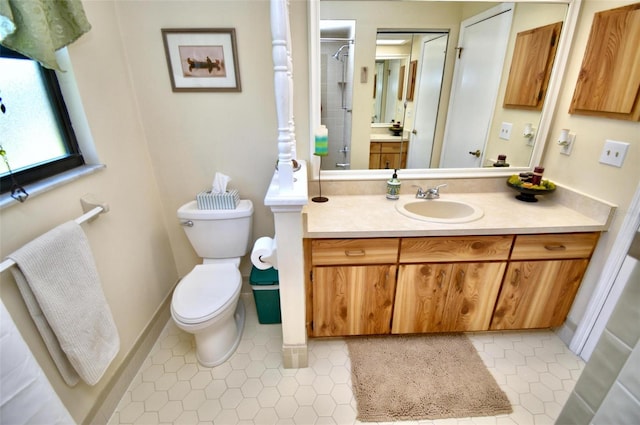 bathroom with toilet, tile patterned flooring, vanity, and tiled shower