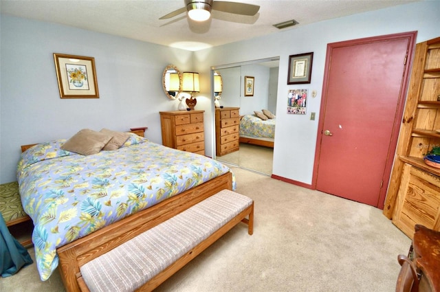 carpeted bedroom featuring visible vents and ceiling fan