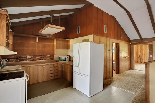 kitchen with a sink, visible vents, wood walls, white appliances, and light floors