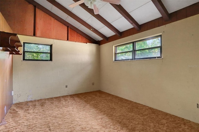 carpeted empty room featuring beamed ceiling, a ceiling fan, and high vaulted ceiling