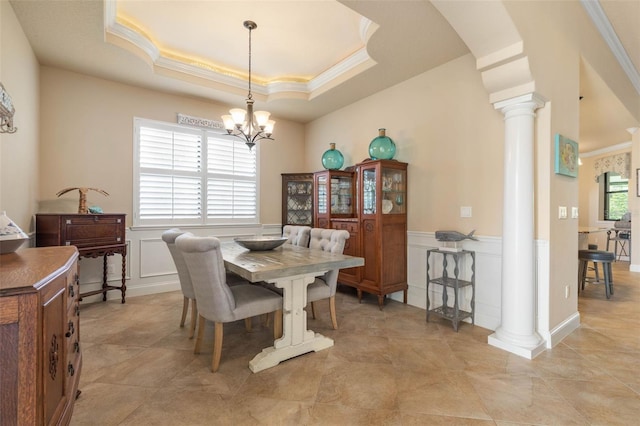 dining space with arched walkways, an inviting chandelier, a decorative wall, ornate columns, and crown molding