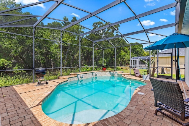 outdoor pool featuring a lanai, area for grilling, and a patio area