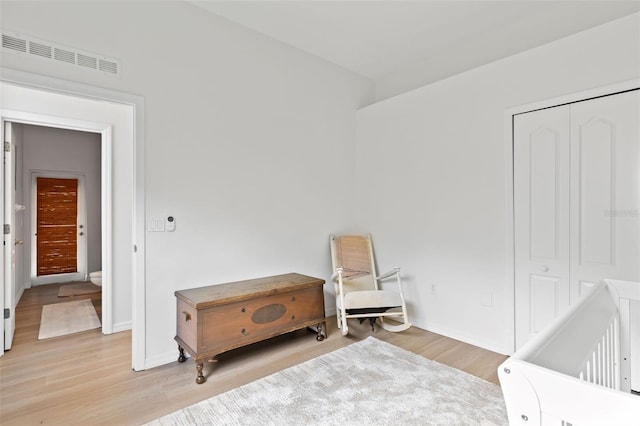 bedroom with visible vents, a closet, baseboards, and light wood-style floors