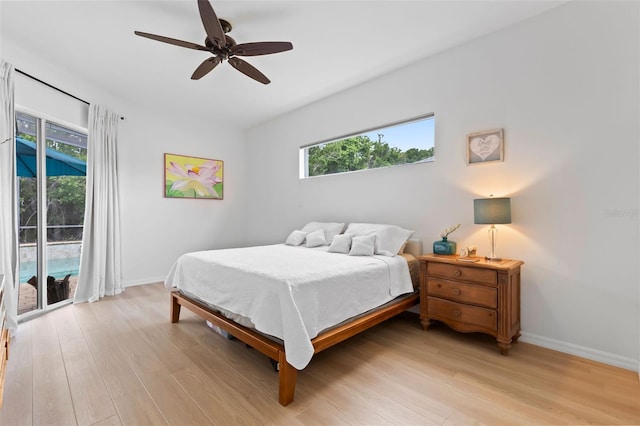 bedroom with baseboards, access to outside, and light wood-style floors