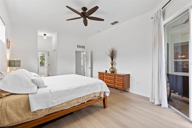 bedroom featuring a ceiling fan, visible vents, baseboards, and light wood-type flooring