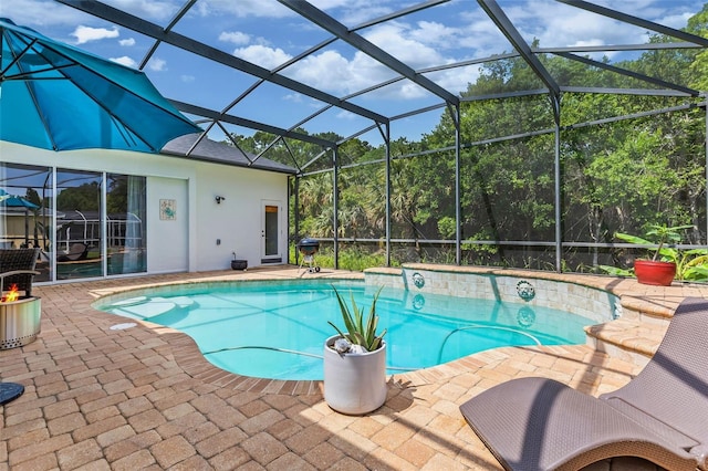 outdoor pool with a patio area and glass enclosure