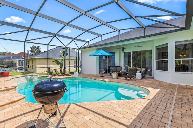 outdoor pool with a ceiling fan, a lanai, and a patio area