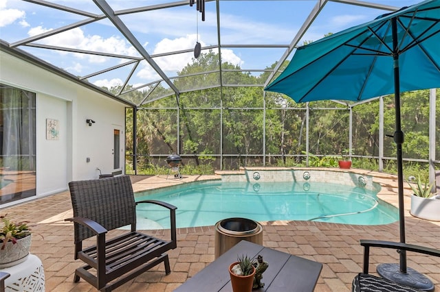 pool featuring a patio, a jacuzzi, and a lanai