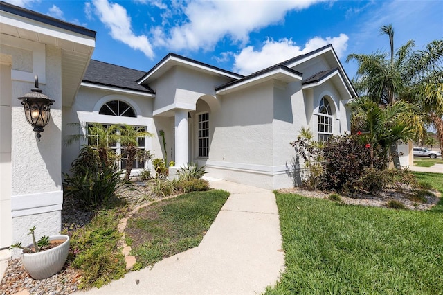 entrance to property featuring stucco siding