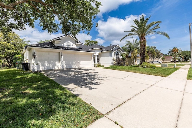 view of front of property with driveway, stucco siding, a front lawn, and a garage