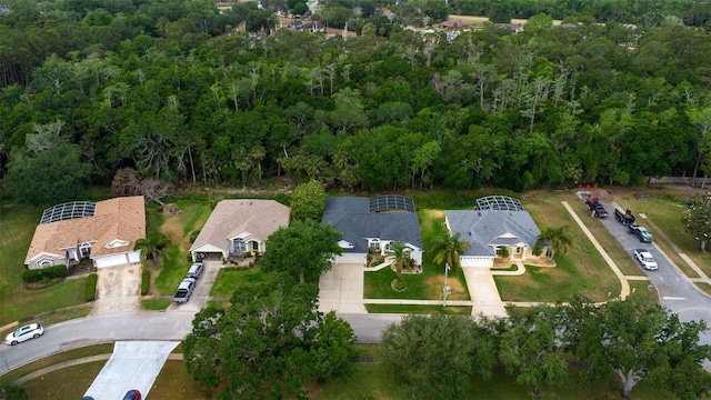 birds eye view of property featuring a wooded view and a residential view