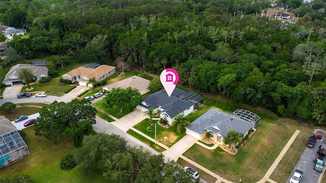 drone / aerial view with a residential view and a view of trees