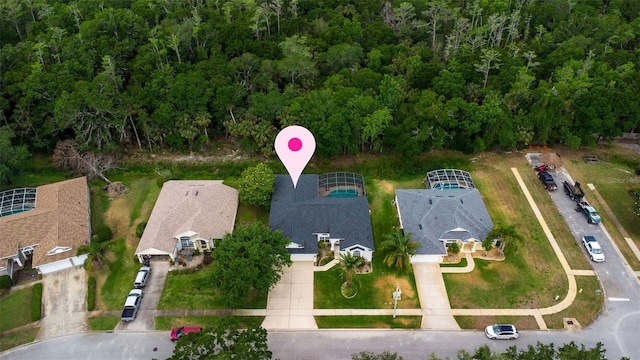 drone / aerial view featuring a forest view
