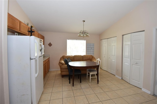 dining room featuring baseboards, light tile patterned flooring, lofted ceiling, and a notable chandelier