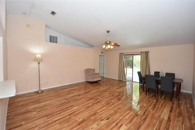 dining room with ceiling fan, vaulted ceiling, light wood finished floors, and visible vents