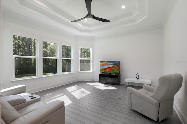 45 King Palm Ct, Ponte Vedra, FL 32081 - living room featuring a raised ceiling, crown molding, wood finished floors, baseboards, and a ceiling fan