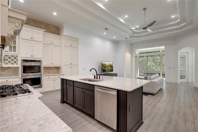 45 King Palm Ct, Ponte Vedra, FL 32081 - kitchen with stainless steel appliances, a sink, arched walkways, ceiling fan, and a tray ceiling