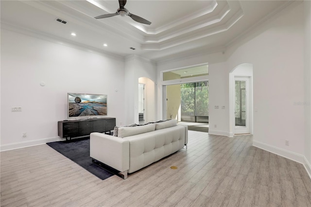 45 King Palm Ct, Ponte Vedra, FL 32081 - living room with arched walkways, crown molding, ceiling fan, wood finished floors, and a tray ceiling