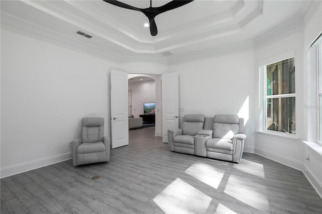 45 King Palm Ct, Ponte Vedra, FL 32081 - living area featuring a raised ceiling, arched walkways, a ceiling fan, wood finished floors, and crown molding