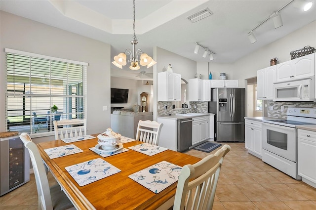 dining room with visible vents, light tile patterned floors, and a chandelier