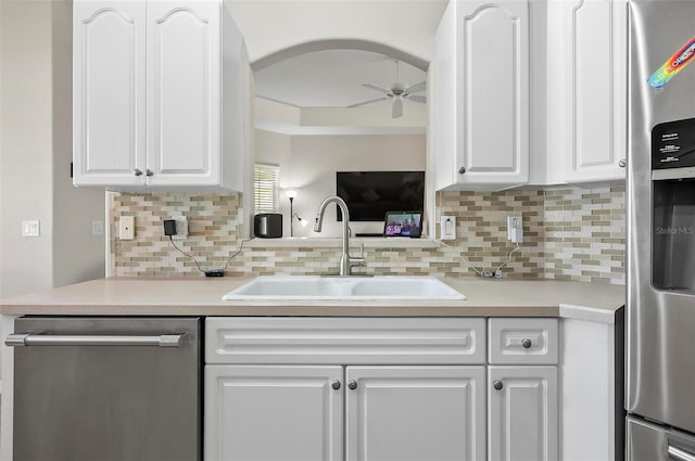 kitchen featuring a ceiling fan, appliances with stainless steel finishes, white cabinetry, and a sink