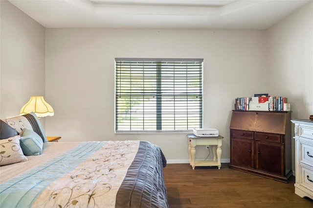 bedroom featuring baseboards and wood finished floors