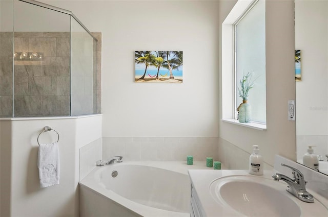 bathroom featuring tiled shower, vanity, and a bath