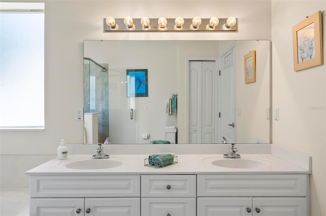 bathroom featuring double vanity, a shower stall, a sink, and a tub to relax in