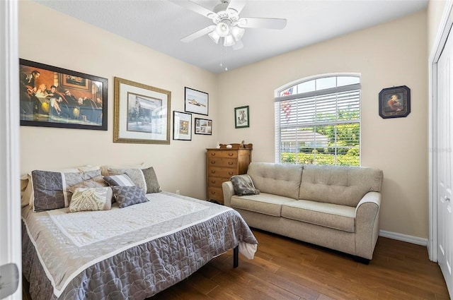 bedroom with baseboards, ceiling fan, and wood finished floors