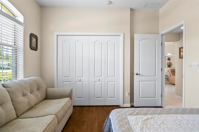 bedroom featuring baseboards, multiple windows, and a closet