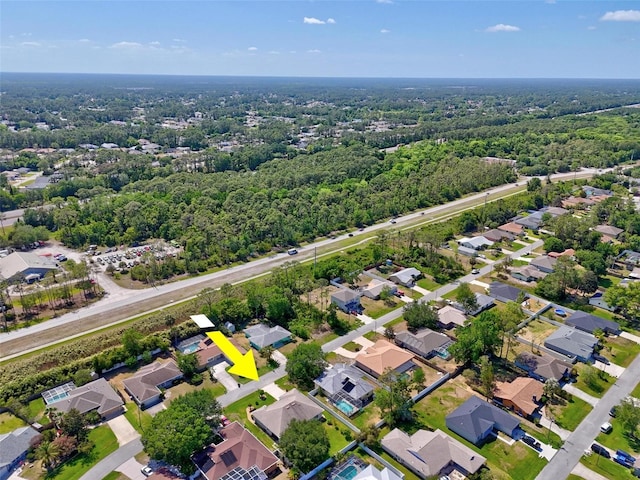 birds eye view of property with a residential view and a view of trees