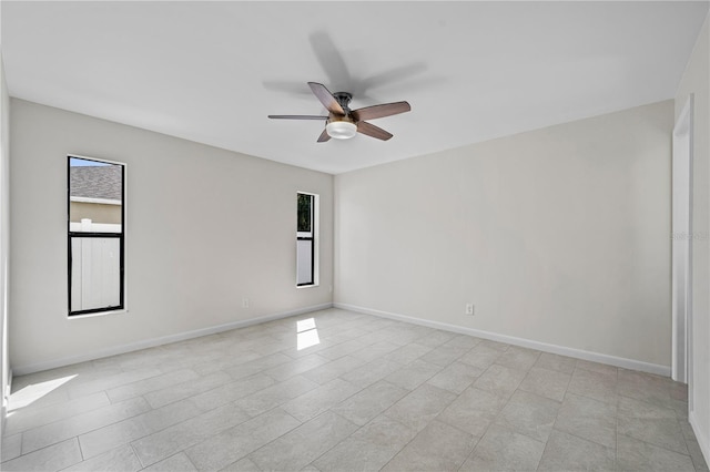 77 Freeport Ln, Palm Coast, FL 32137 - spare room with plenty of natural light, a ceiling fan, and baseboards