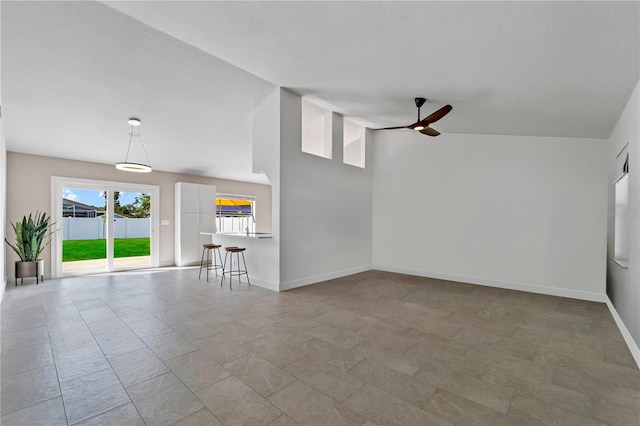 77 Freeport Ln, Palm Coast, FL 32137 - unfurnished living room featuring ceiling fan and baseboards