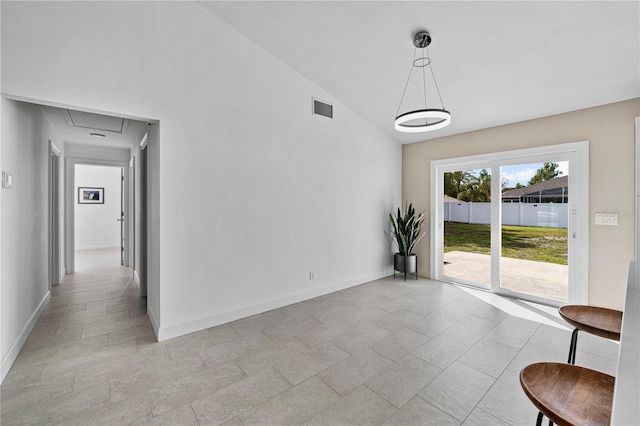 77 Freeport Ln, Palm Coast, FL 32137 - unfurnished dining area with attic access, baseboards, and high vaulted ceiling